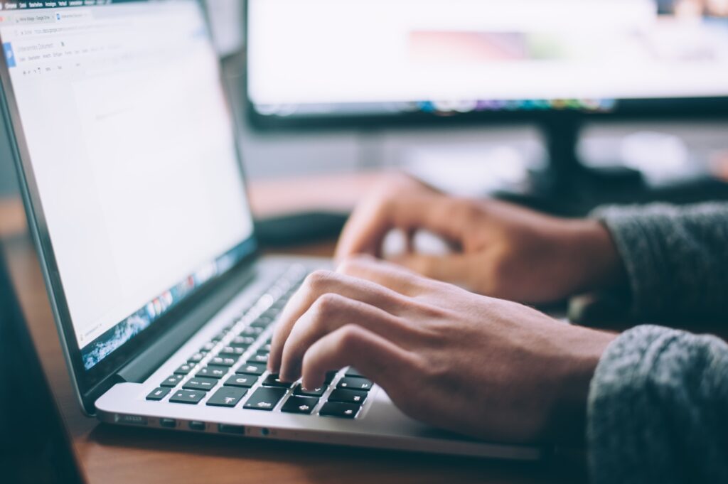 A person typing, working on website.